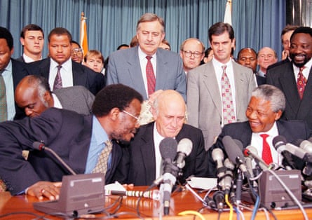 Rows of men in suits including Roelf Meyer, Cyril Ramaphosa, Chief Mangosuthu Buthelezi, President FW de Klerk and Nelson Mandela.