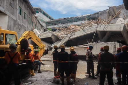 Rescuers search for survivors at the boarding school in Sidoarjo, East Java.