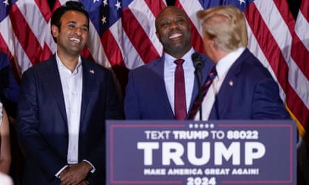 Donald Trump looks at Tim Scott as Vivek Ramaswamy laughs at a primary election night party in Nashua, New Hampshire, on 23 January.