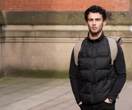 Jordan Wallace in black jacket carrying a backpack