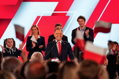 The Polish presidential candidate Karol Nawrocki, backed by the main opposition Law and Justice (PiS) party, speaks beside his wife, Marta Nawrocka, his sons, Antoni and Daniel, and his daughter, Katarzyna, as the exit poll results come in.