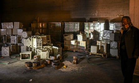 A man stands by electrical storage components that were used to hide pills of Captagon, a brand name of the psychostimulant drug Fenethylline, at the warehouse of a drug manufacturing facility in the city of Douma in the Eastern Ghouta region on the eastern outskirts of Damascus on 12 December 2024.
