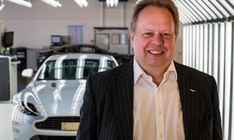 Andy Palmer,   Aston Martin boss, smiles at the camera in front of one of their cars