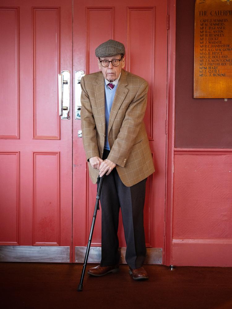 Trefgarne standing up, leaning on a walking stick.