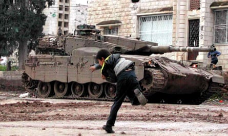 A Palestinian boy throwing rocks at a tank in Jenin, 2003.