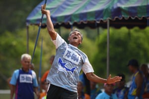 A man in the 75-80 age category competing in the javelin