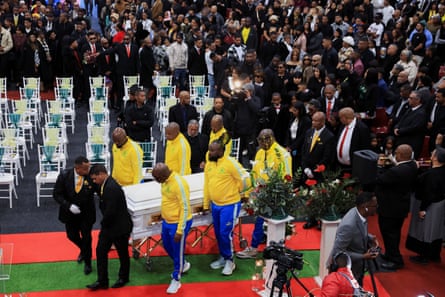 Members of the Mamelodi Sundowns football club carry Jayden Adams’ coffin at the funeral service for the player