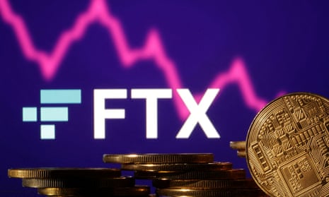 Representations of cryptocurrencies are seen in front of displayed FTX logo and decreasing stock graph
