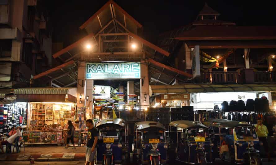 Tuk tuk drivers wait for customers outside an unusually-empty night market in Chiang Mai in 2020