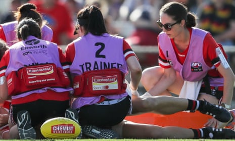 An AFLW player is stretchered off with concussion during a 2020 match. Sports Medicine Australia has defended its position at a Senate inquiry.