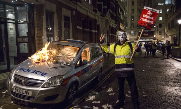 Protester next to burning police car