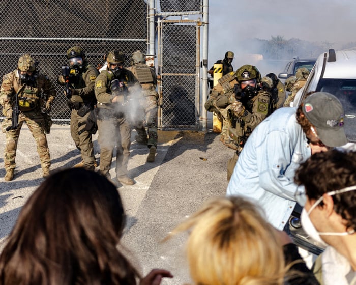 Ice agents use teargas on protesters outside Chicago facility – video