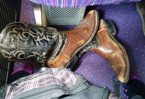 cowboy boots in the footwell of a train