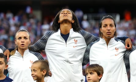 Marion Torrent, Wendie Renard, and Sarah Bouhaddi of France sing the national anthem prior to the group A match between France and Norway at Stade de Nice.
