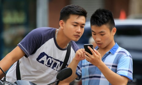 Two men play Pokémon Go in Hanoi, Vietnam.