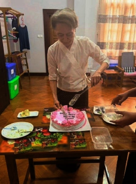 Aung San Suu Kyi cuts a birthday cake.