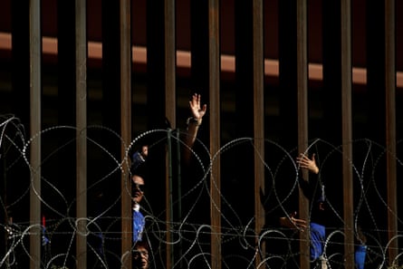 People wave from behind the border fence in El Paso, Texas, before a brief reunification meeting for relatives separated by deportation and immigration, as pictured from Ciudad Juárez in October 2019.