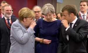 Theresa May, centre, speaks with Germany’s Angela Merkel and France’s Emmanuel Macron as they enter the EU summit in Brussels.