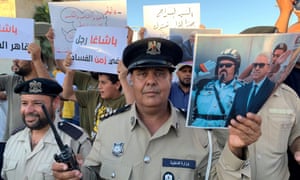 Police with posters supporting Bashagha