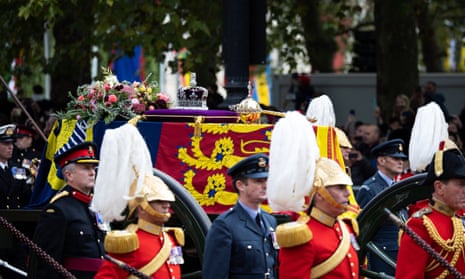 Queen Elizabeth II’s coffin is carried on a gun carriage pulled by Royal Navy service personnel during the funeral procession down the Mall in central London.