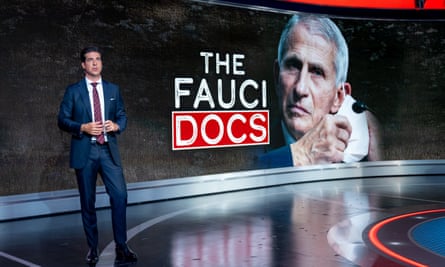 Watters stands in front of image that says ‘the fauci docs’