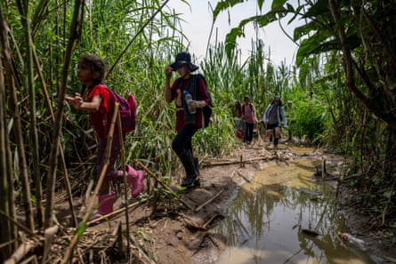 Migrants walk in the jungle near Bajo Chiquito village, Darién province, Panama.