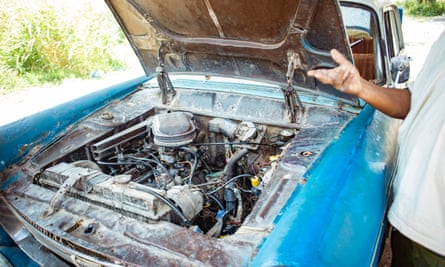 Alemu Yama looks under the hood of his Peugeot 404. “A car never dies with quality,” he says.