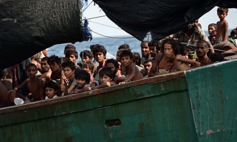 Rohingya migrants sit on a boat drifting in Thai waters