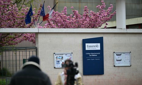 A TV crew stands outside Les Sablons middle school in Viry-Chatillon filming