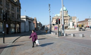 Hull town centre in daytime with one woman crossing a street