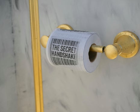 A roll of toilet paper with “The Secret Handshake” written on it.