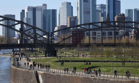 People at the embankment of the Main river during a partial lockdown in Frankfurt.