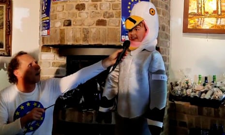 Cooper Wallace dressed as a seagull with a microphone held to his mouth by a man