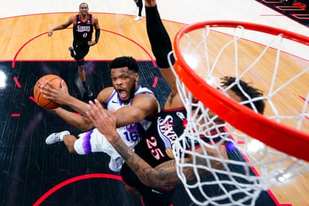 Utah Jazz’s EJ Harkless (left) goes up for a shot against Philadelphia 76ers’ Dom Barlow.