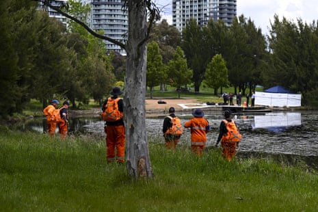 Members of the SES search the waterfront at Yerrabi pond in Canberra