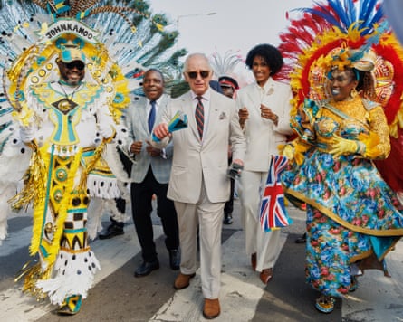 King Charles shakes traditional cowbells as he parades with Junkanoo dancers in Nassau.