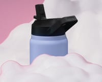 purple water bottle emerging from soap suds