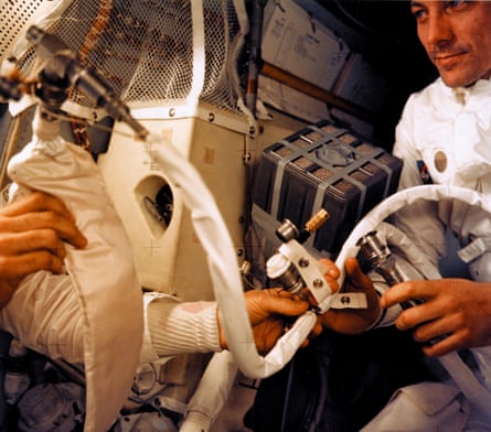 jack swigert (right) and one of the other two crew members work an improvised co2 scrubber made from parts found aboard the apollo 13 lunar module