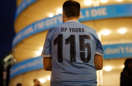 Manchester City fan wearing a âÂÂ115, up yoursâ t-shirt at the stadium before the Champions League match against PSG
