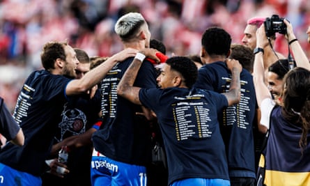 Girona players celebrate Champions League qualification in custom-made T-shirts.