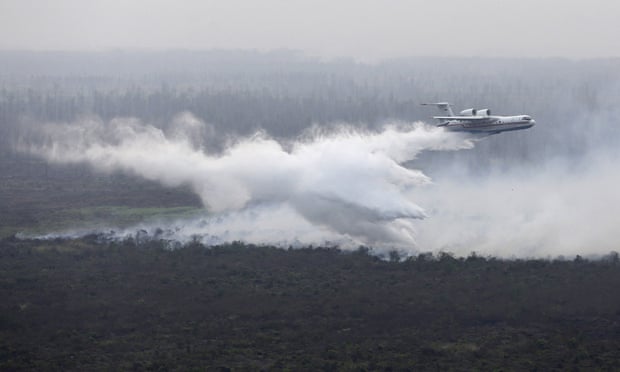 A leased Russian Beriev BE-200 water bomber drops its payload over a fire in Ogan Komering Ilir, South Sumatra.