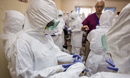 WHO staff training nurses to use protective gear in Freetown, Sierra Leone during the 2014 ebola outbreak.