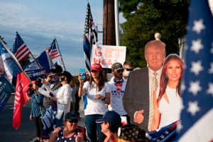 TOPSHOT-US-POLITICS-TRUMP-HEALTH-VIRUSTOPSHOT - Supporters of the US president hold flags as they rally outside of Walter Reed Medical Center in Bethesda, Maryland on October 4, 2020, where the president is being treated for Covid-19. - US President Donald Trump waved at supporters from a motorcade on October 4 on a short drive outside the hospital where he was being treated for Covid-19. (Photo by Alex Edelman / AFP) (Photo by ALEX EDELMAN/AFP via Getty Images)