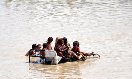 People affected by floods wait for relief in Sukkur, Sindh province, Pakistan.
