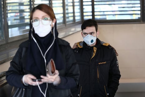 Iranian people wear protective masks to avoid coronavirus infection in Tehran