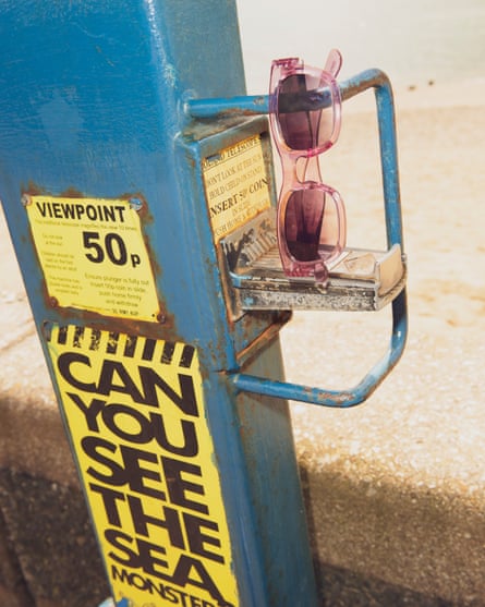 Pink, £50, Izipizi sunglasses hanging artfully on a coin slot for a viewfinder telescope at a beac