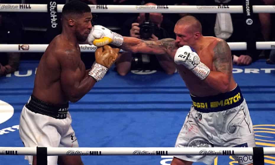 Anthony Joshua takes a punch from Oleksandr Usyk in September 2021 in their fight in London.