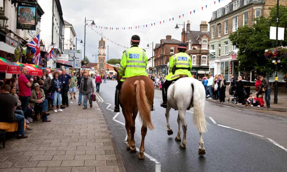Mounted police on horses patrolling the High Street in Newmarket.