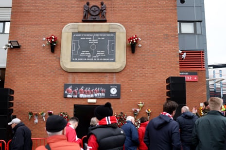 Fans pay their respects next to the Munich air disaster memorial at Old Trafford