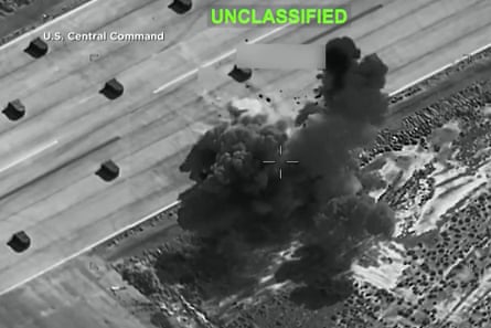 Black and white picture shows smoke and dust rising from an explosion.